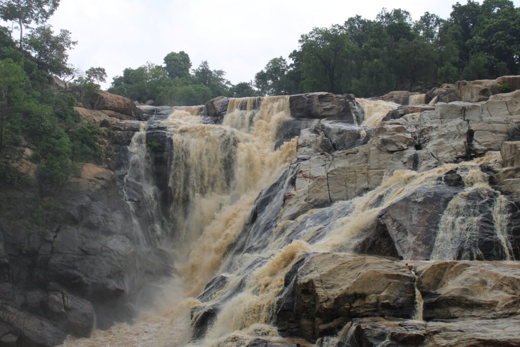 A beautiful waterfall cascading over rocky terrain in Ranchi, India.